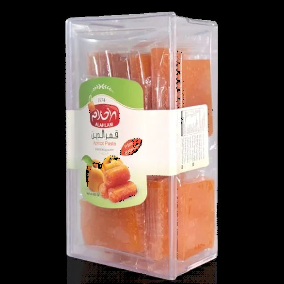 A clear plastic rectangular box containing orange-colored honeycomb candies, with a white and green label featuring the brand name 'Al-Masnad' and the product name 'Honeycomb Candies'.